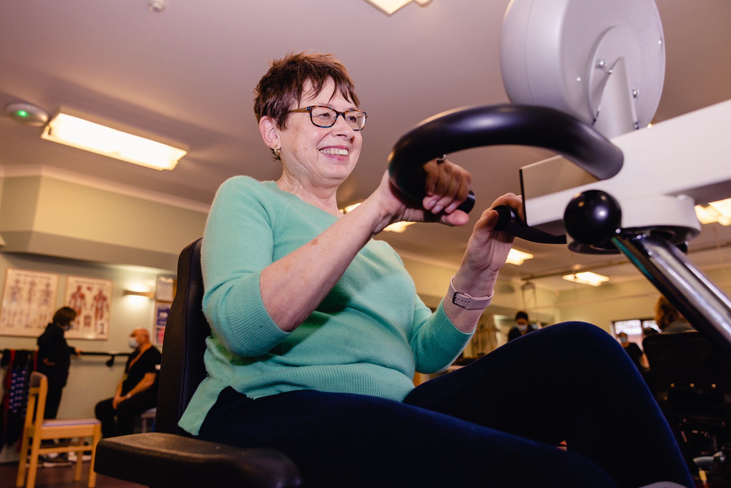 Woman smiling on an exercise bike